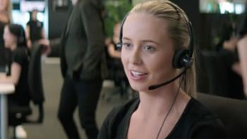Friendly looking woman wearing a telephony headset. 