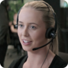 A friendly looking woman wearing a telephony headset