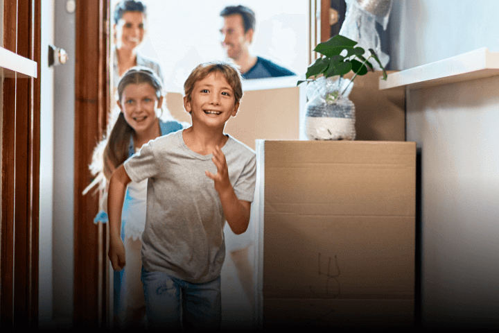 Image of a young family moving in to a new house with kids running around