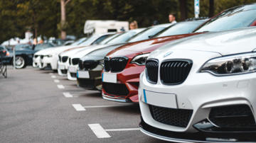Cars parked next to one another at a dealership