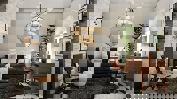 A cosy living room with a desk setup by the window