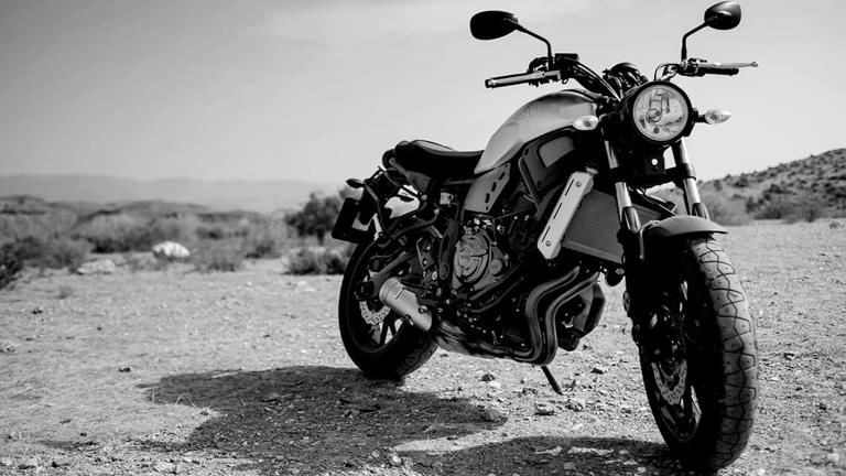 Motorbike parked on a grass hill.