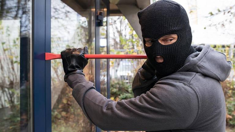 Burglar trying to open door with a crowbar