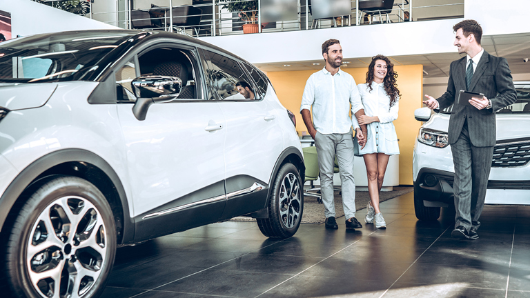 People standing in a car showroom