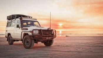 4wd parked on a beach. 