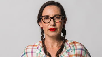 Image of Eleni wearing a colourful shirt.