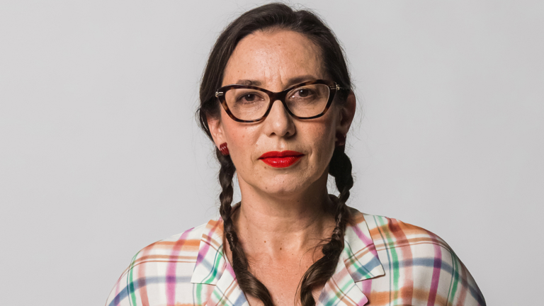 Image of Eleni wearing a colourful shirt.