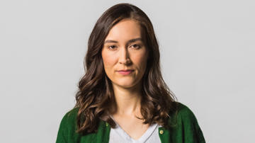 Image of Rebecca looking straight faced.