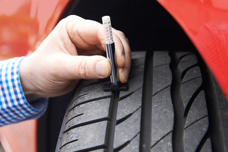 Person Reading Tyre Tread