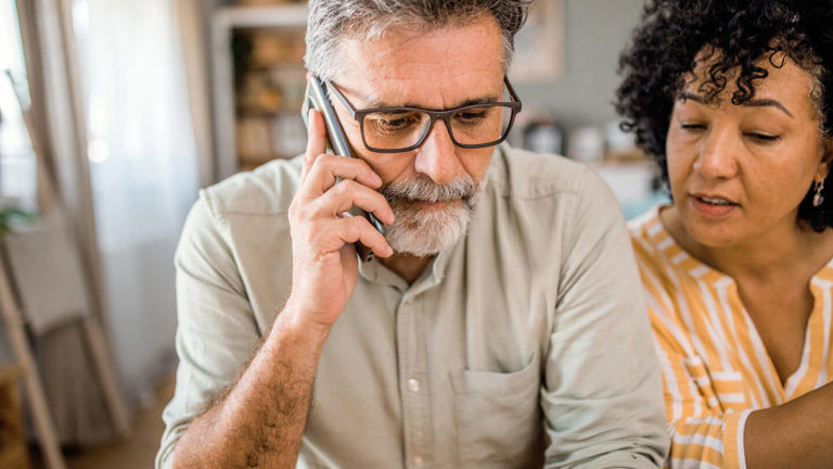 A man on the phone to his insurer to make a claim after a kitchen fire.