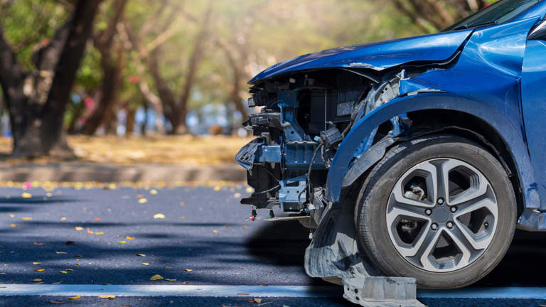 Image of a blue car that has been in a accident.