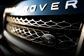 The front grill of a blue Land Rover