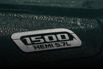 A Ram 1500 badge on a black vehicle.