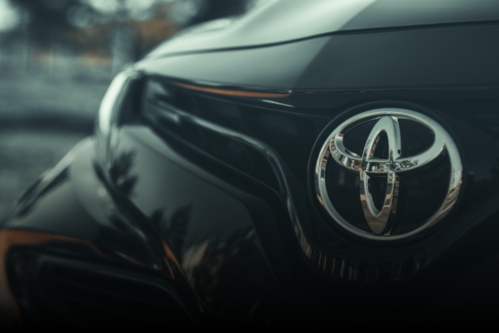A Toyota badge on the front of a black car.