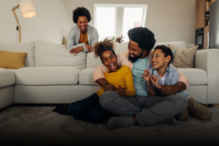 A family playing in the living room.