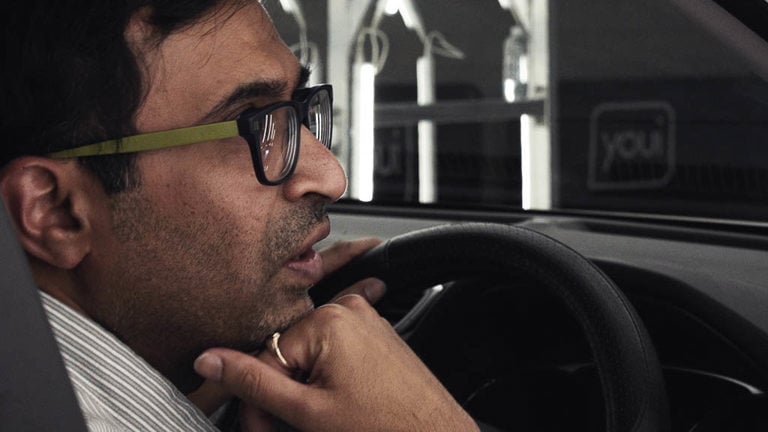 Saurabh sitting in his parked car as it gets assessed by a Youi assessor